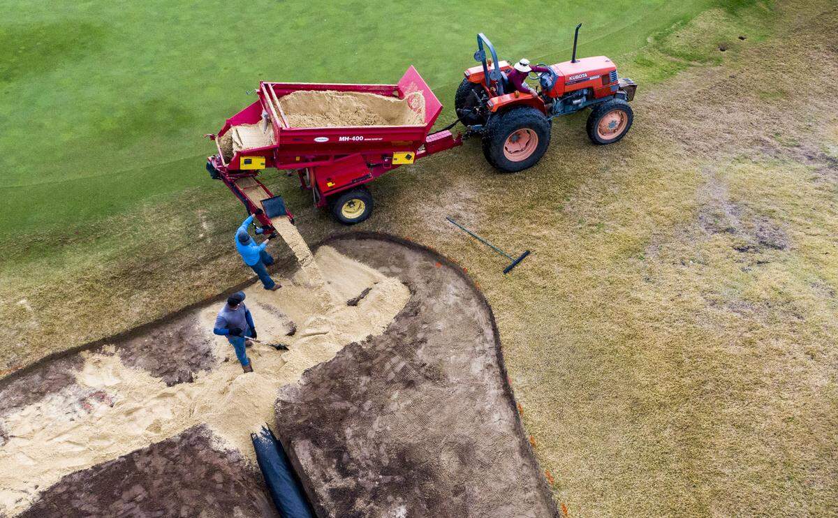 Crews work to add new sand into a bunker on the ninth hole at the Members Club at Grande Dunes in Myrtle Beach on Jan. 15, 2020.
