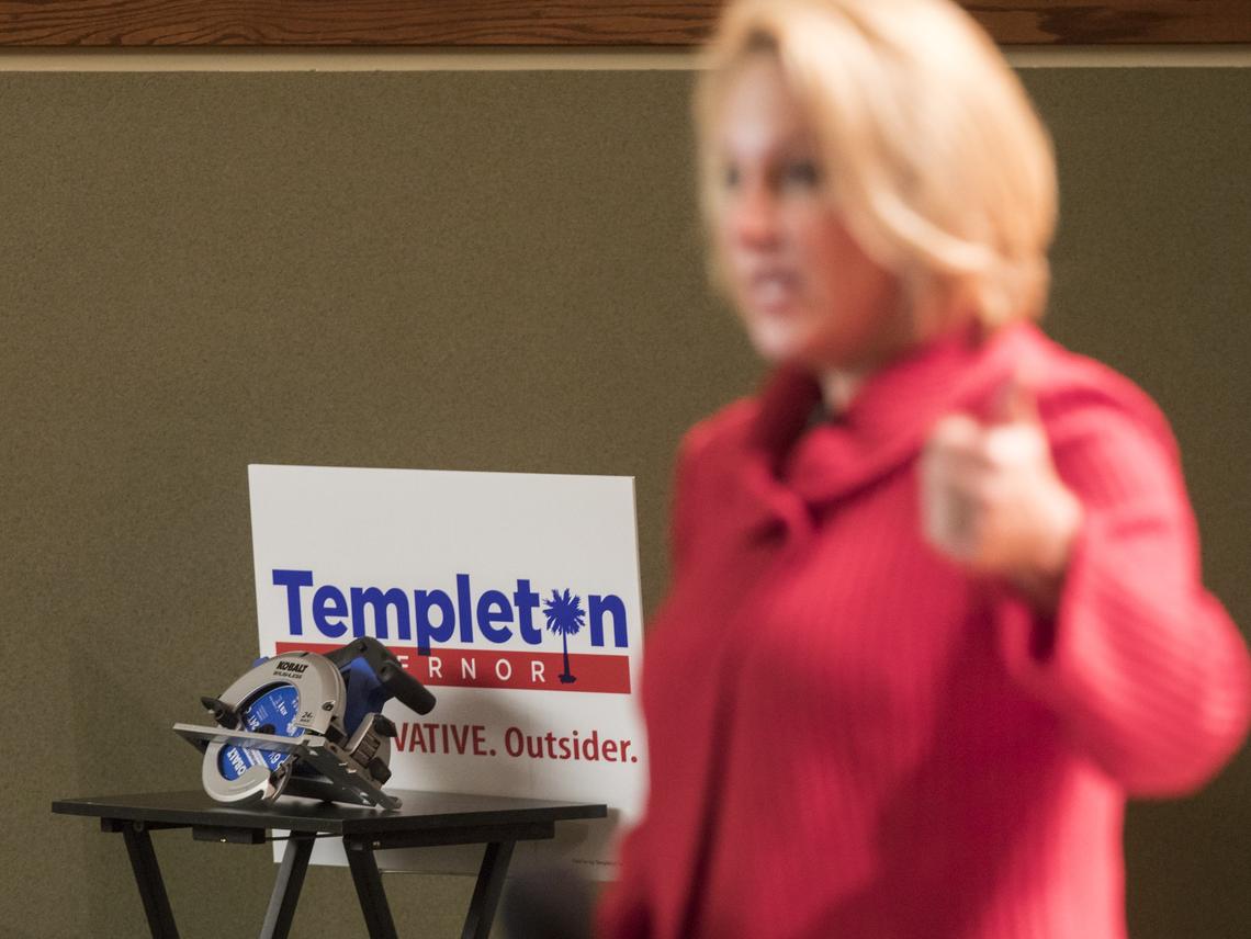 Catherine Templeton, who has embraced the nickname the "buzzsaw," stands in front of a prop as she talks about her plan to cut taxes and government spending at the Horry County GOP meeting with republicans on Monday night at Horry Georgetown Technical College in Conway. April 9, 2018.