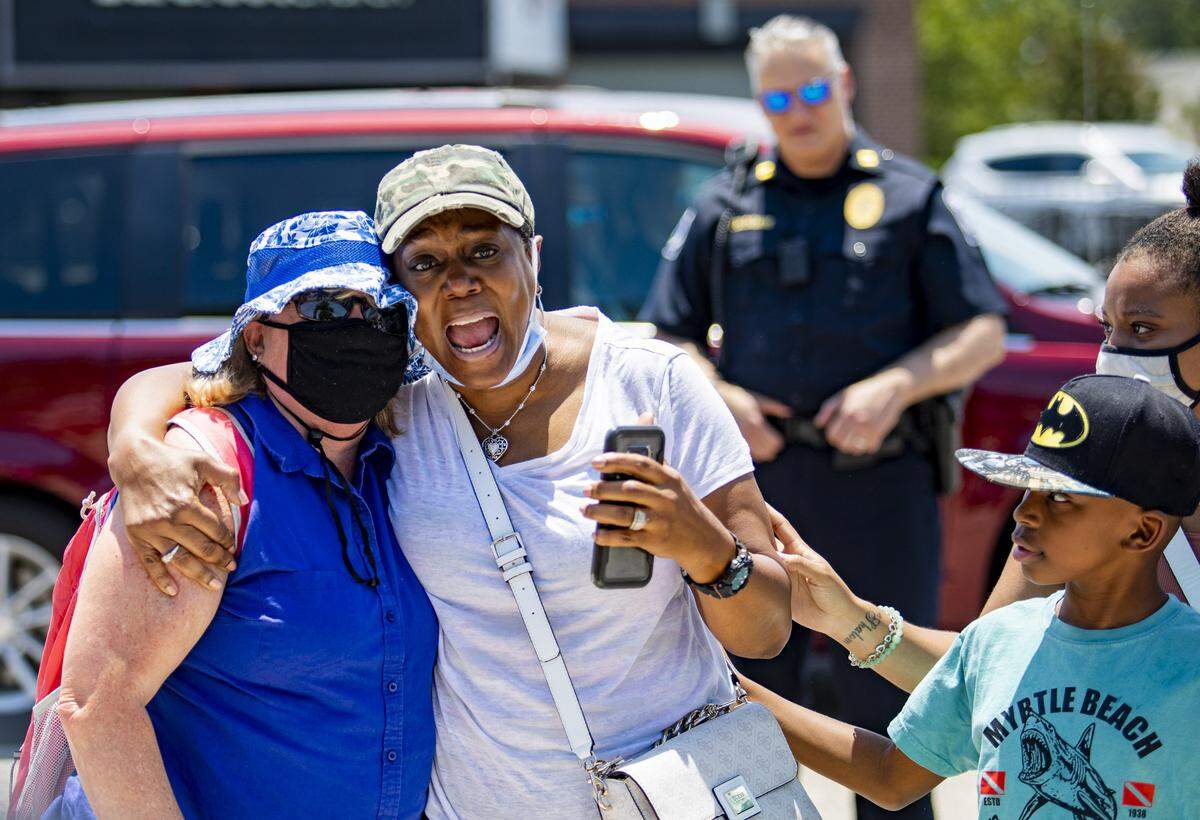North Myrtle Beach resident Roberta Broomer embraces Ocean Isle Beach resident Sue Williams while speaking to a crowd gathered along Main Street in North Myrtle Beach Tuesday afternoon after protesters marched through the city to protest police brutality and the murder of George Floyd, who was killed by Minneapolis, Minn. police officer Derek Chauvin on May 25.