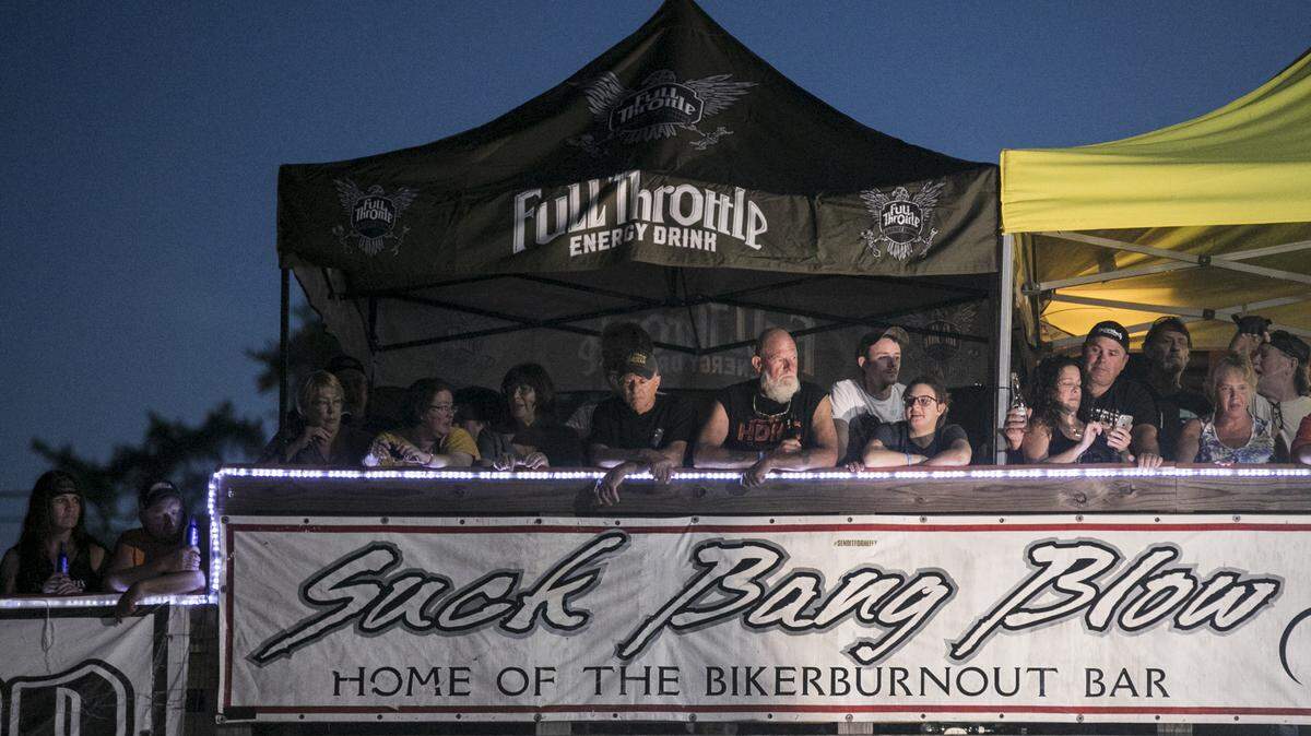 Spectators watch as a biker burns out his tires at Suck Bang Blow. Biker’s by the thousands visit the bars in Murrells Inlet on Friday night of the Myrtle Beach Spring Bike Rally. May 17, 2019.