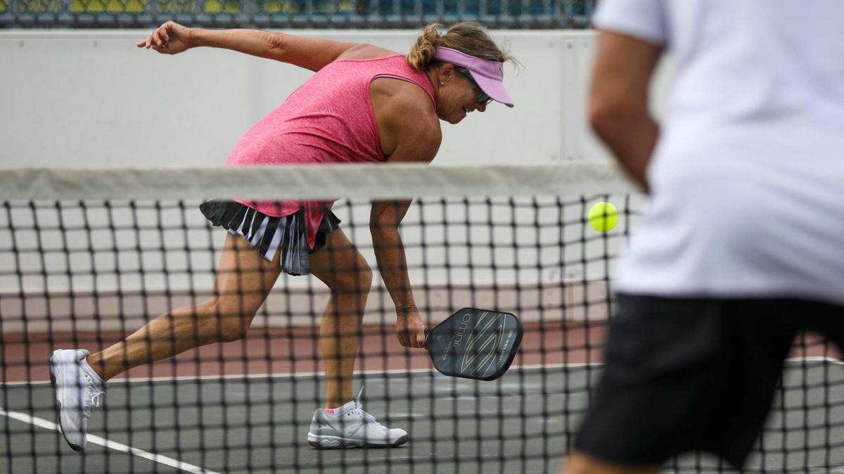 Lynn Palmer reaches for a back hand during doubles pickle ball play in Central Park, North Myrtle Beach, S.C. on October 17, 2022. North Myrtle Beach’s 2024 budget contains $1 million dedicated to building new pickleball courts.