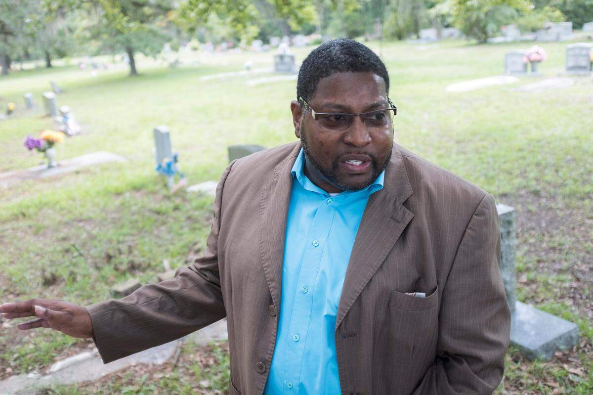 Cedric Blain-Spain, a community activist in Conway, points out graves of ancestors that could be damaged by a proposed perimeter road through the Sandridge Community off U.S. Highway 378. Part of the Ride III plan, some of the proposed routes for Conway Perimeter Road Phase II, which would connect U.S. 378 to U.S. 701, could displace members of the community and threaten historic landmarks. July 15, 2019.