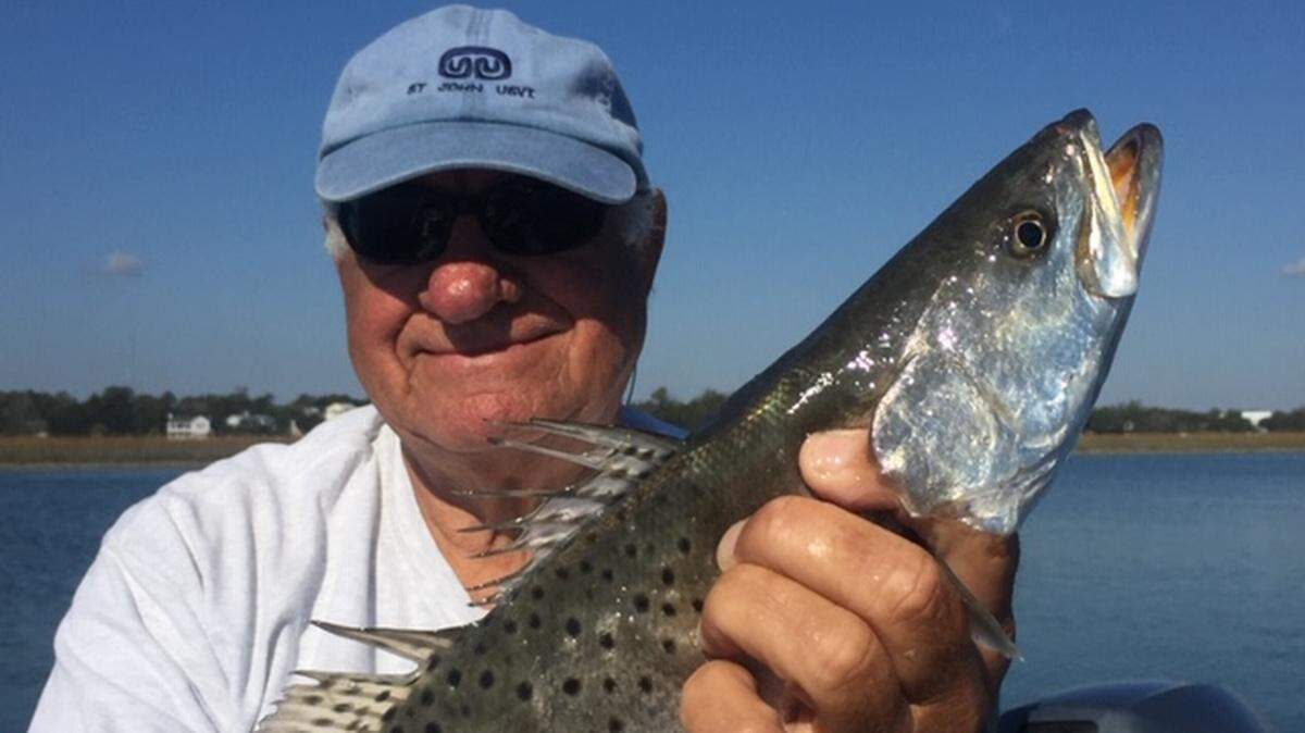Charlie Nash of Garden City Beach holds a spotted seatrout he caught. Action for the fish is heating up in local estuaries.