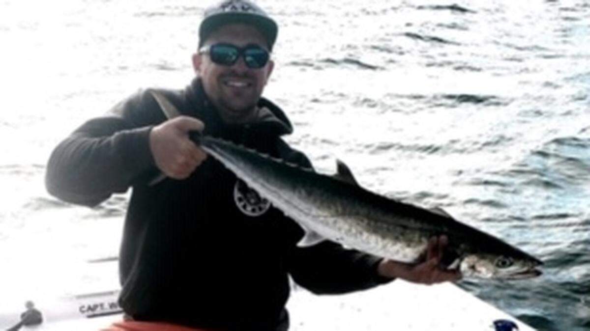 Ray England shows off a king mackerel caught Thursday while fishing with Capt. Dan Connolly of O-Fish-Al Expeditions just off the beach out of Murrells Inlet.
