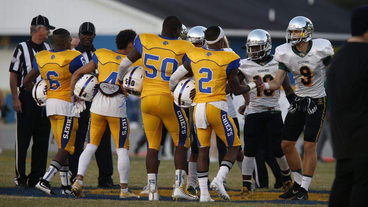 Players shake hands after the coin toss during the annual Battle of the Beach game between Myrtle Beach and North Myrtle Beach last season.