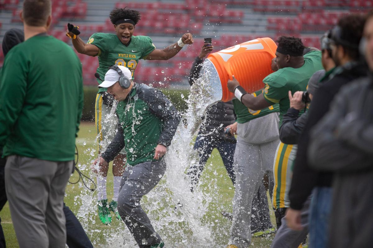 Myrtle Beach head coach Mickey Wilson receives a Gatorade bath after the Seahawks clinched the win Friday at Williams-Brice Stadium over the Greer Yellow Jackets in the S.C. Class 4A state championship game.