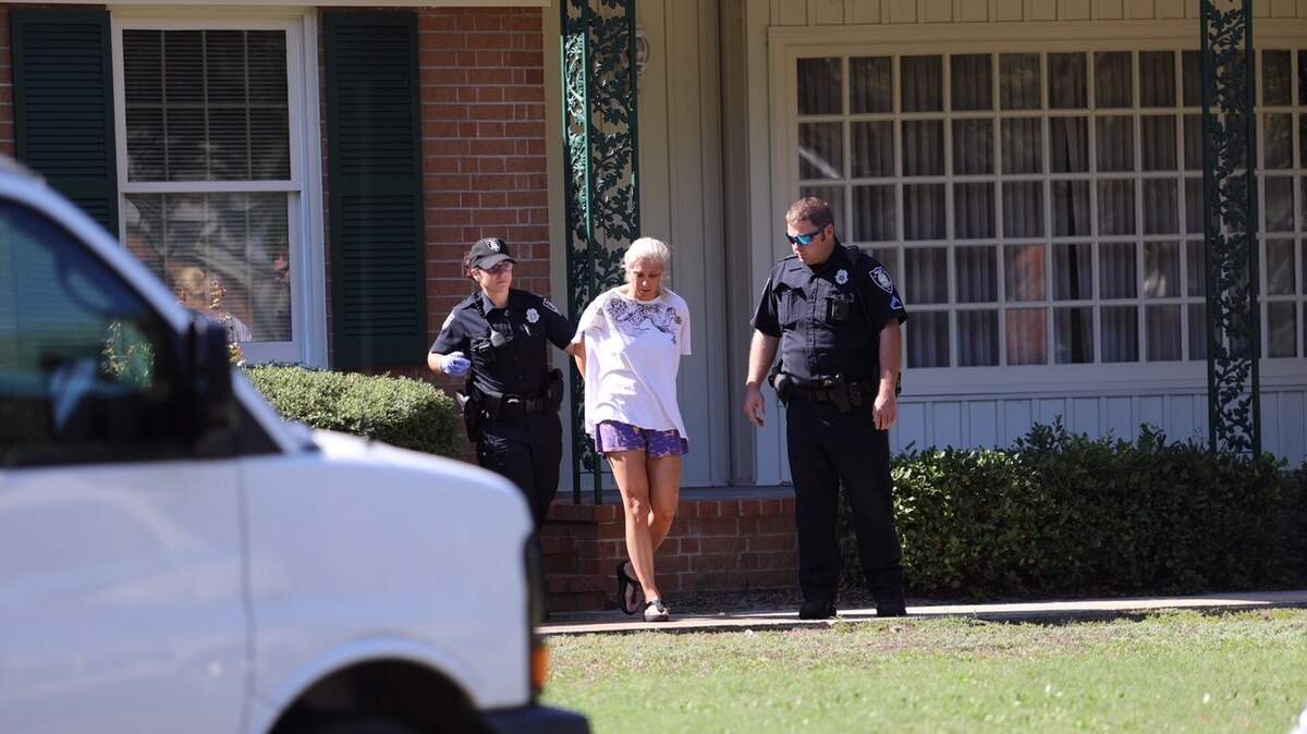 Myrtle Beach police handcuff one woman at the scene of an apparent drug investigation Tuesday near Dunes Golf & Beach Club.