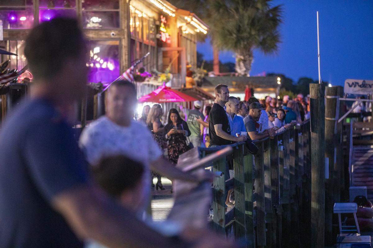 People stroll the Murrells Inlet Marsh Walk on Saturday evening. With hotels, beaches, shopping and restaurants reopening along the Grand Strand, tourist season kicked off this weekend despite coronavirus concerns. May 16, 2020