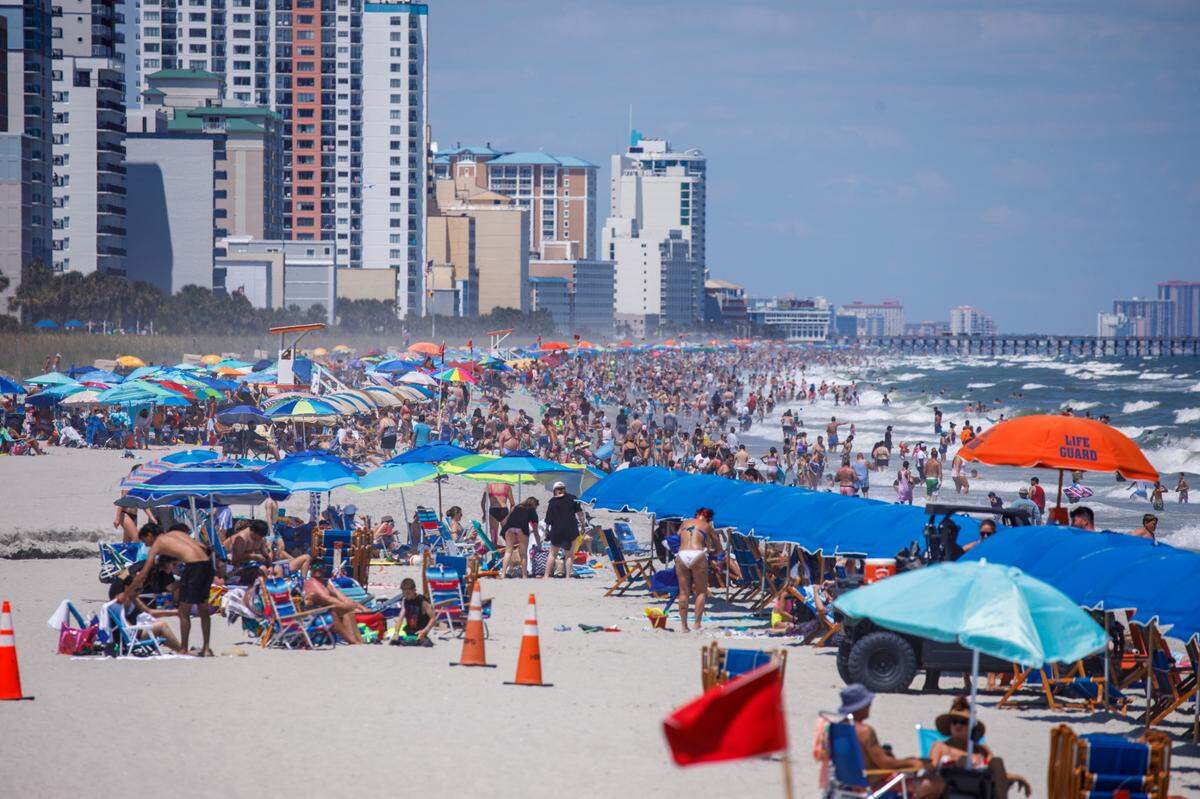View from the Springmaid Pier looking North at swimmers and sunbathers in Myrtle Beach on Tuesday. The week of July 4th is one of the times for tourism in the Myrtle Beach area. July 2, 2024.