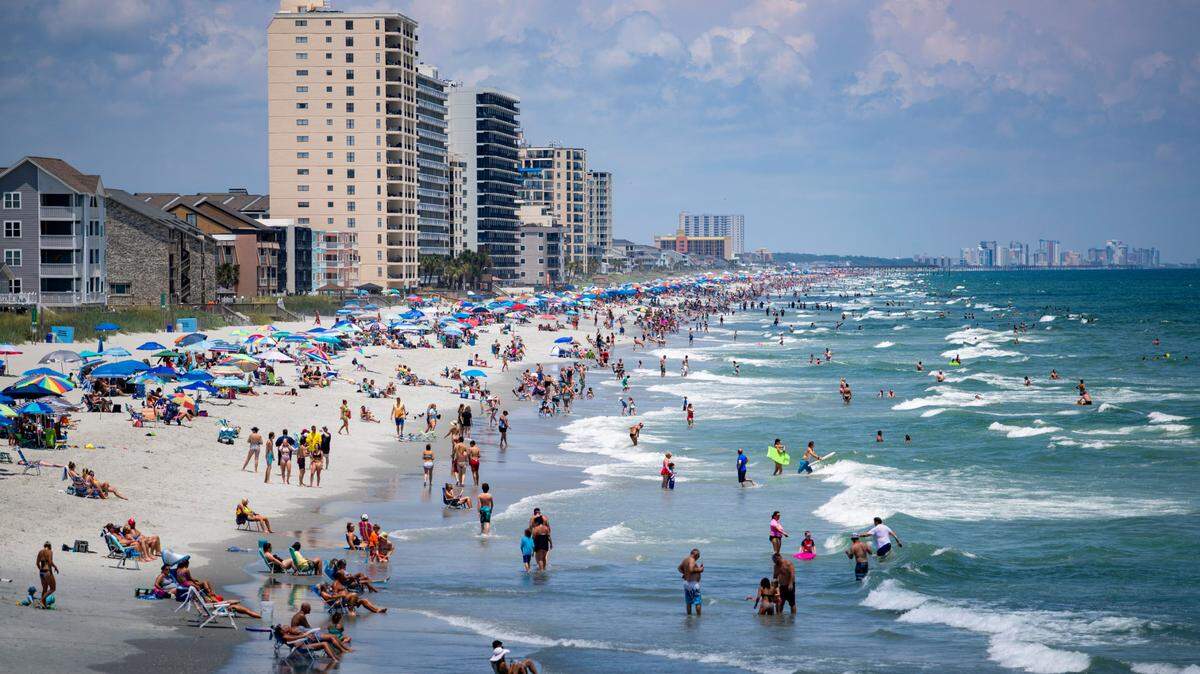 Beachgoers crowd the beach near the Garden City Pier in Garden City Thursday afternoon.