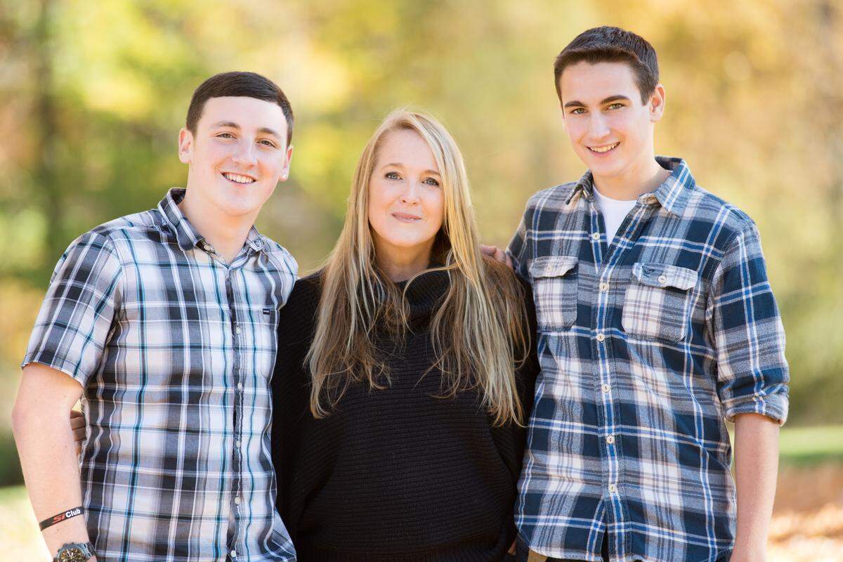 Ryan Mancuso, left, his mother Robin Mancuso-Startup and brother Kyle Mancuso pose for a family photo.