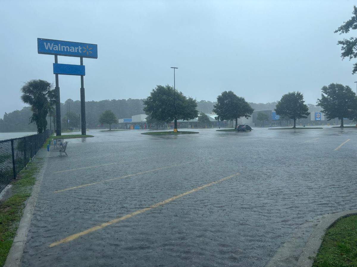 The parking lot of the Kings Road Walmart, 10820 Kings Road, has began flooding. Overflow from a retention pond spilled into the lot, with water going over the wheels of a shopping cart.