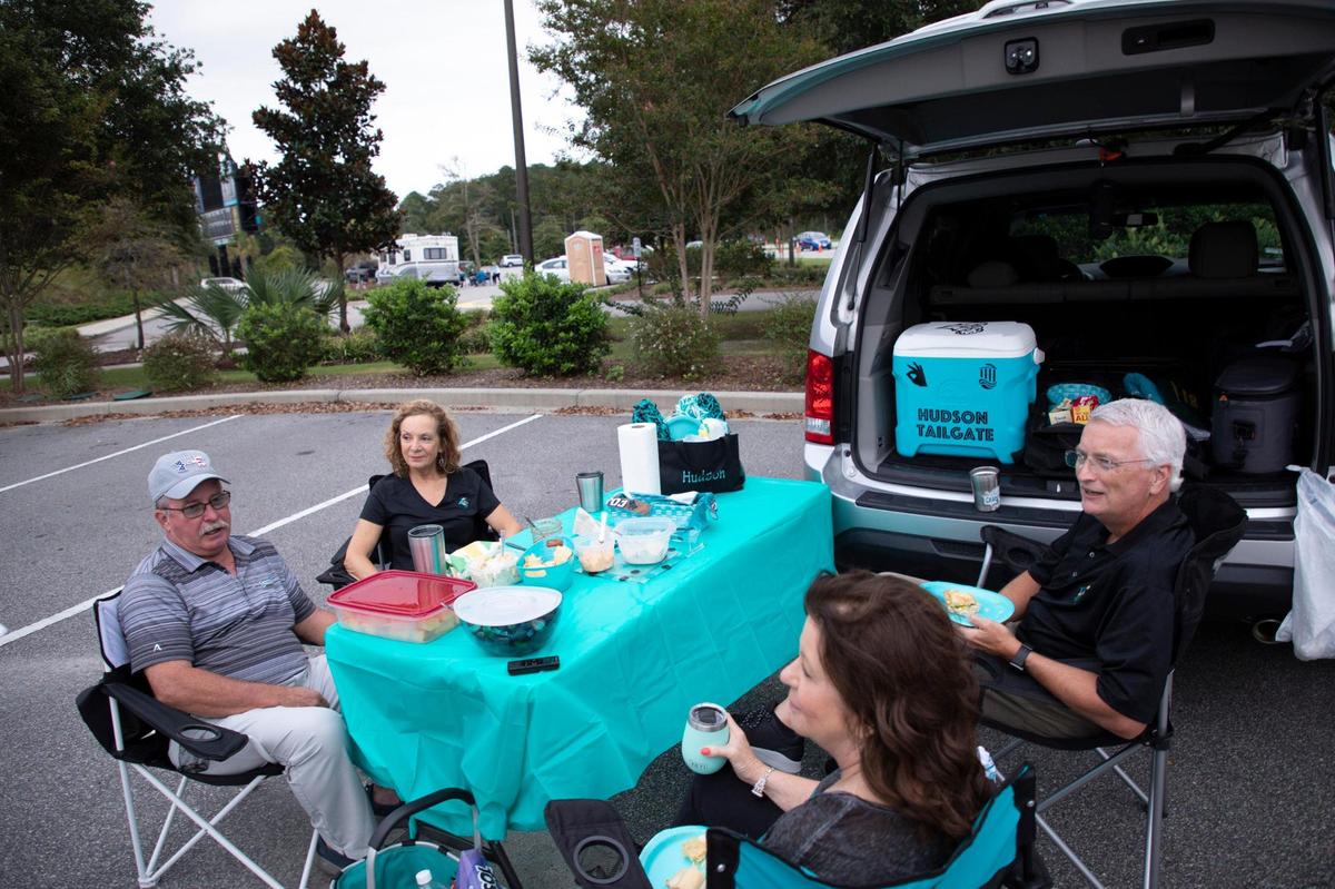 Dean Hudson, right, with family and friends enjoy dinner before the first home game at Coastal Carolina on Friday. Coastal Carolina University football hosted Campbell during it’s 2020 home-opening game at Brooks Stadium in Conway, SC. on Friday night with strict guidelines in an attempt to guard against the spread of the coronavirus. Only 5,000 fans were allowed to sit in the stands. September 18, 2020.