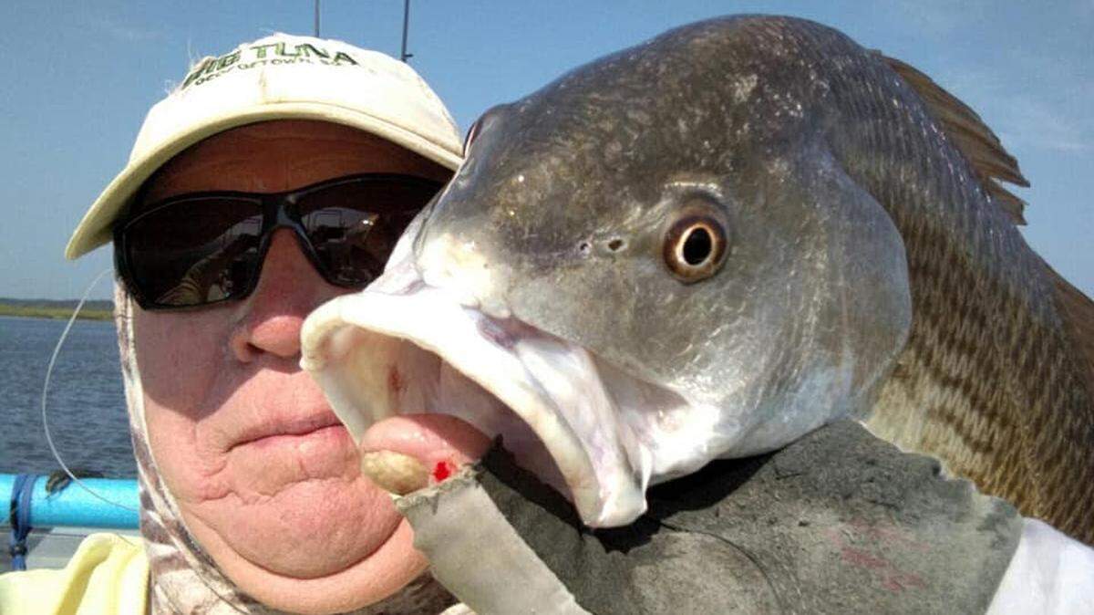 Capt. Mike McDonald of Gul-R-Boy Guide Service in Georgetown shows off a red drum caught in the Winyah Bay area this week.