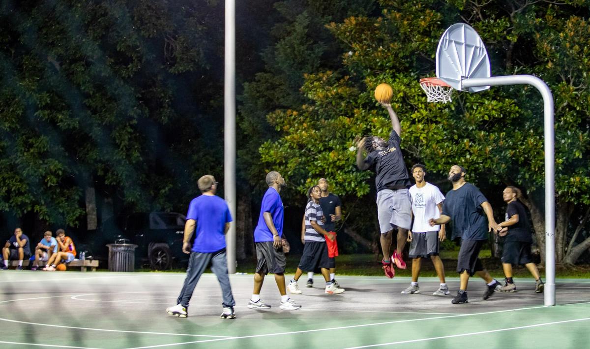 Myrtle Beach residents participate in a game of pick-up basketball on the basketball court at Midway Park in Myrtle Beach Sunday evening.