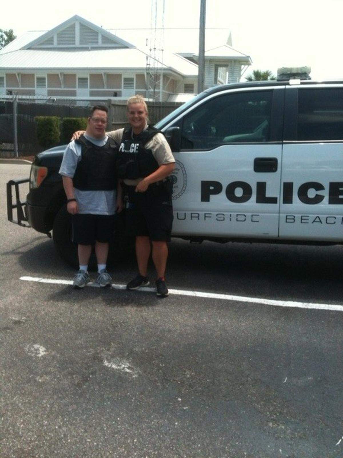 Dave Leperi standing with Cpl. Kim Decker, a Surfside Beach police officer before his ride along in June.