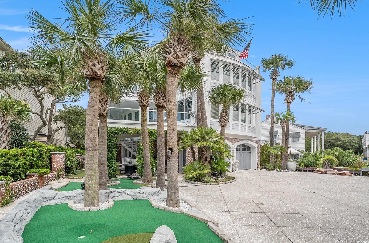 The 5729 Ocean Boulevard North estate comes with its own putting greens.