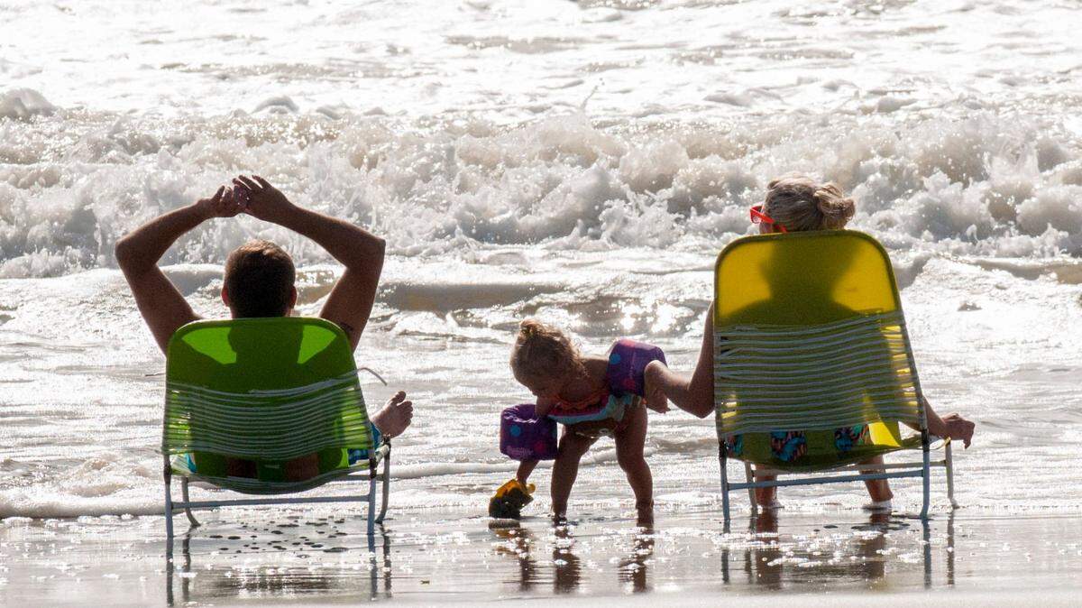A family enjoys time on the shore in downtown Myrtle Beach. This month the Grand Strand could see above-normal fall temperatures.