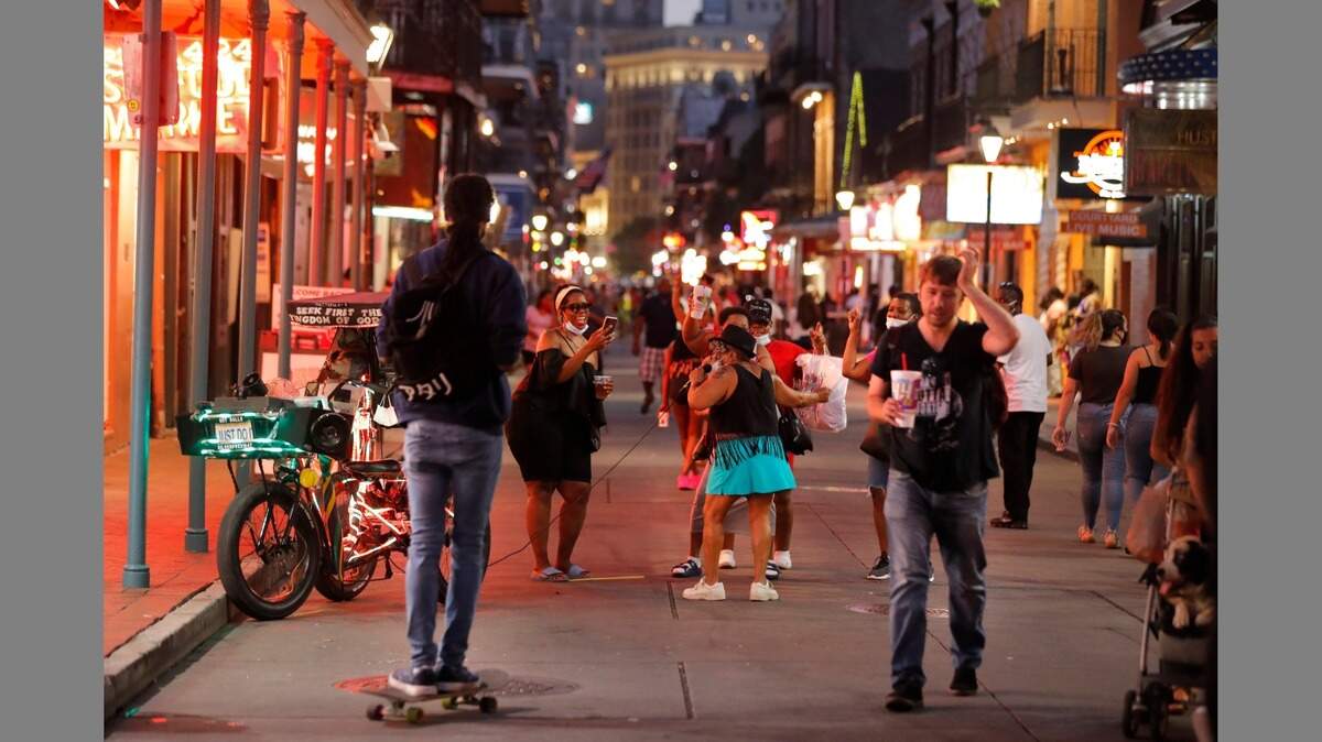 People sing and dance to karaoke on Bourbon Street in New Orleans. A sharp increase in COVID-19 cases and hospitalizations is forcing many New Orleans bars to shut down again after reopening. Should South Carolina take a tougher stand on bars to lower the state’s surging COVID-19 rates? (AP Photo/Gerald Herbert)