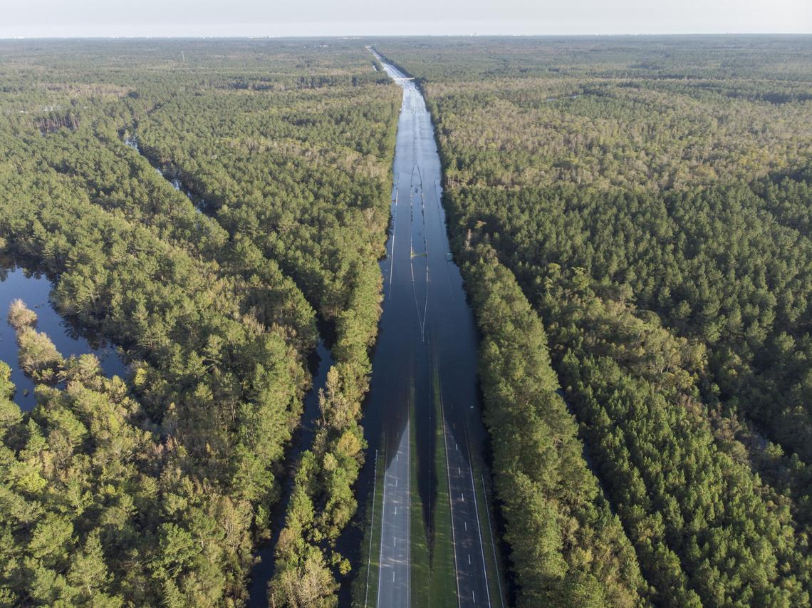 S.C. Highway 22 is flooded between Hwy. 90 and Hwys 905 on Saturday. An officer with the S.C. State Highway Patrol marks the water level to compare against previous days. The blocked road has traffic snarled around Conway, S.C. Sept. 22, 2018.