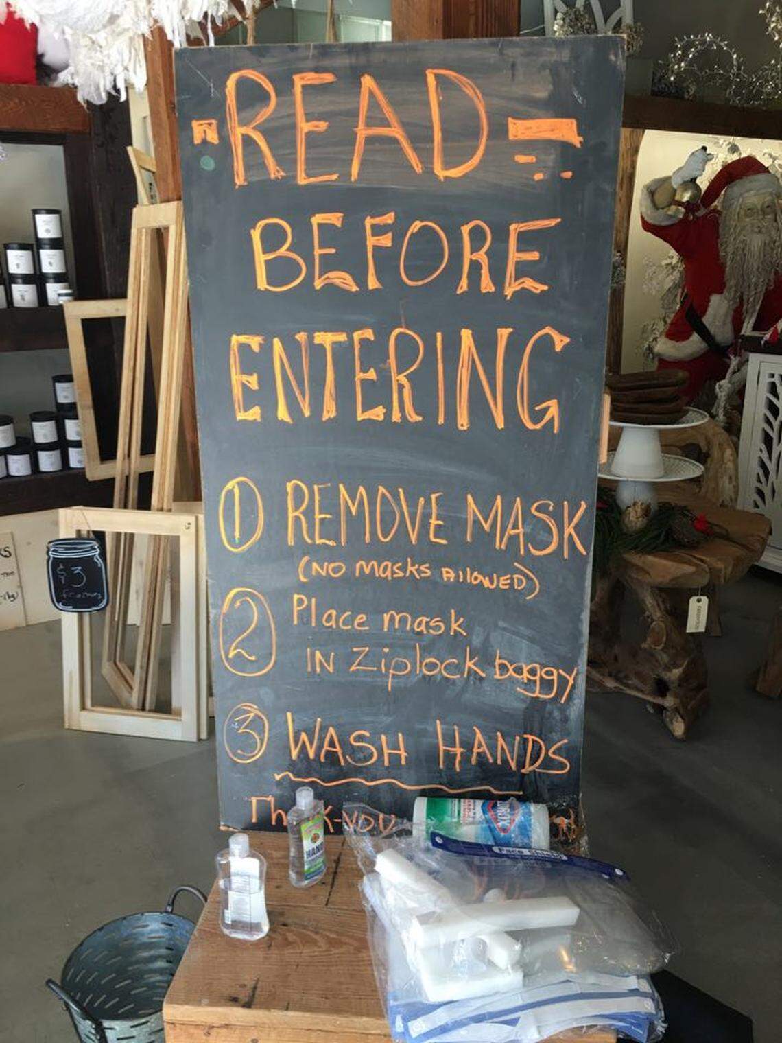 This sign at The Barn home decor store in Mullins, South Carolina tells customers what to do to comply with the store’s strict no mask policy.