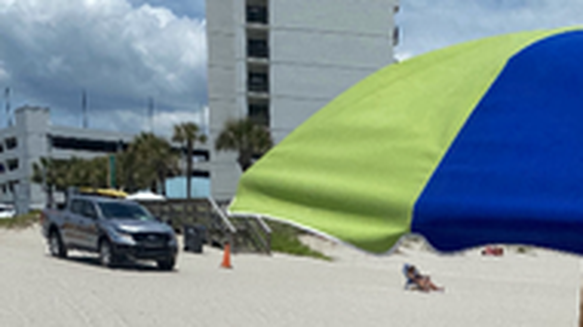 A photo taken minutes before a beachgoer was ran over by an Horry County beach patrol officer Thursday, June 13, 2024, shows the victim sitting in her beach chair and the patrol truck nearby. The photos was taken at 1 p.m. near the Nash Street beach access outside of Myrtle Beach, SC. The woman later died from her injuries at a local hospital.