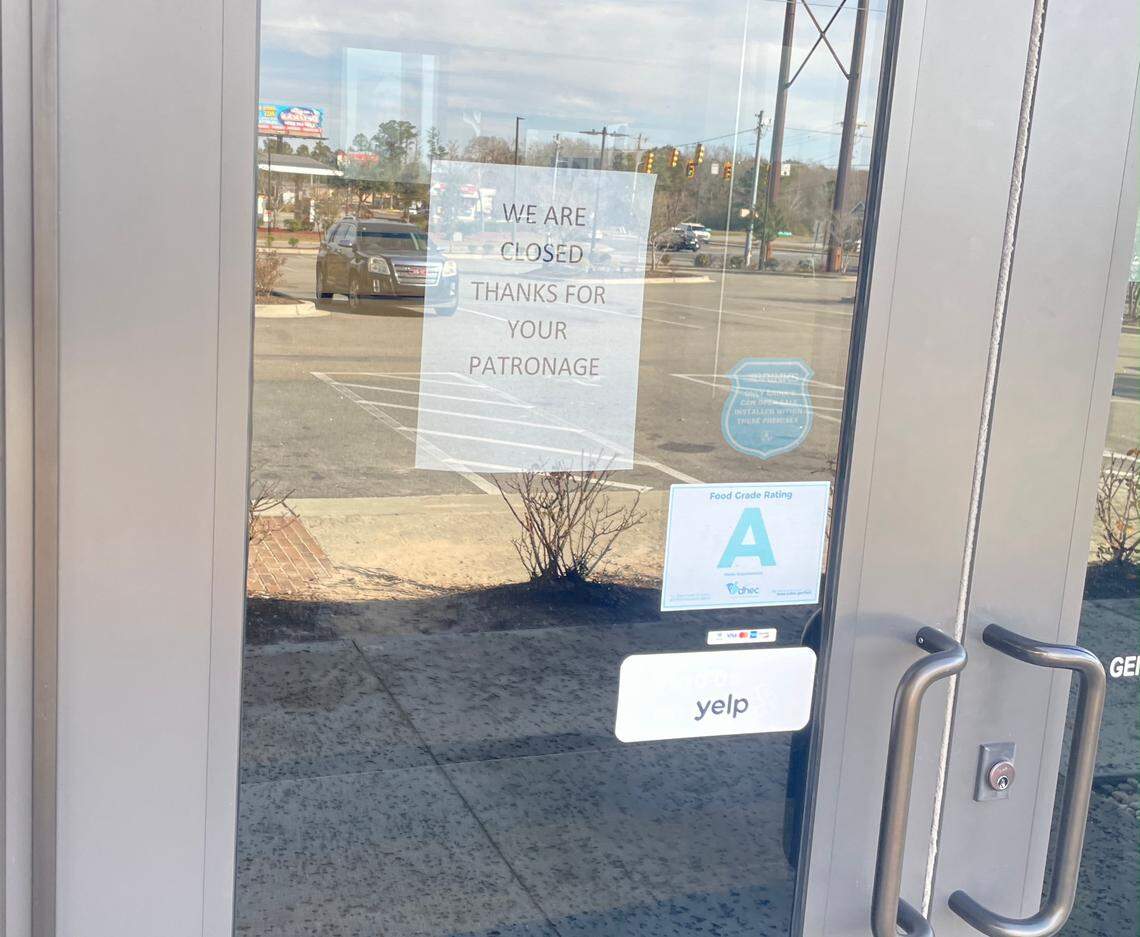 A closed sign hangs in the doorway of Eugenia’s Steak & Seafood in Conway, SC.