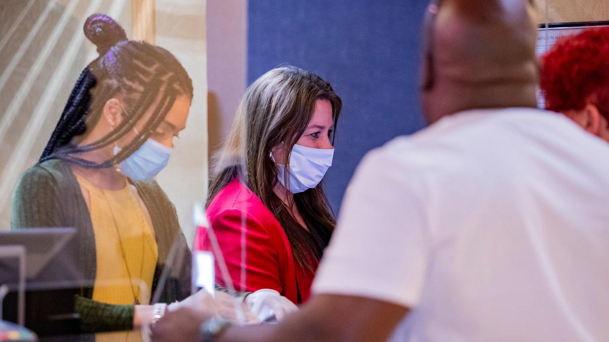 Captain’s Quarters front desk representatives check vacationers in Friday afternoon as Myrtle Beach hotels and short-term lodging rental businesses prepared to reopen after county and municipal governments lifted restrictions on reservations forced by the coronavirus outbreak.C