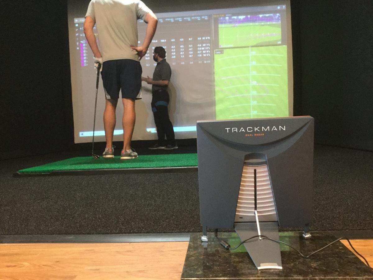 Master fitter Kolton Ostler (right) goes over swing and ball-striking statistics with customer Jeff Smith of Myrtle Beach at the new Club Champion business.