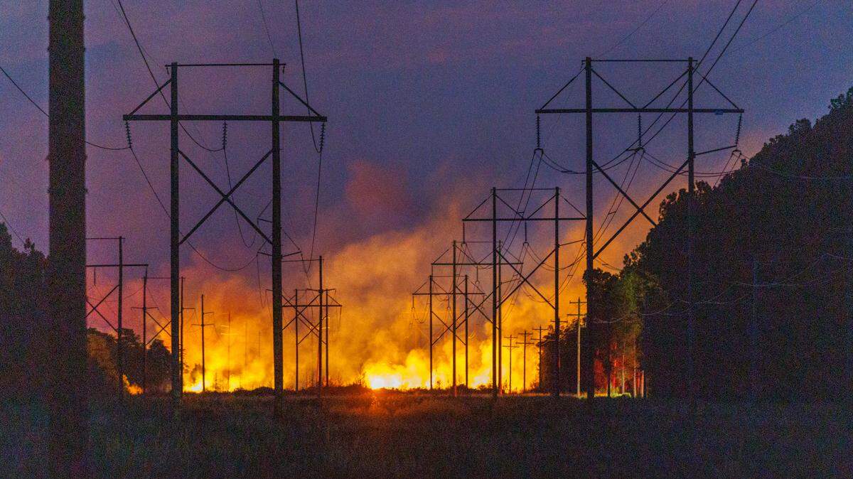 Evacuations continued over night for communities in the Carolina Forest area threatened by a forest fire. Firefighters and residents worked to protect their homes from the flames. Sunday, March 2, 2025.