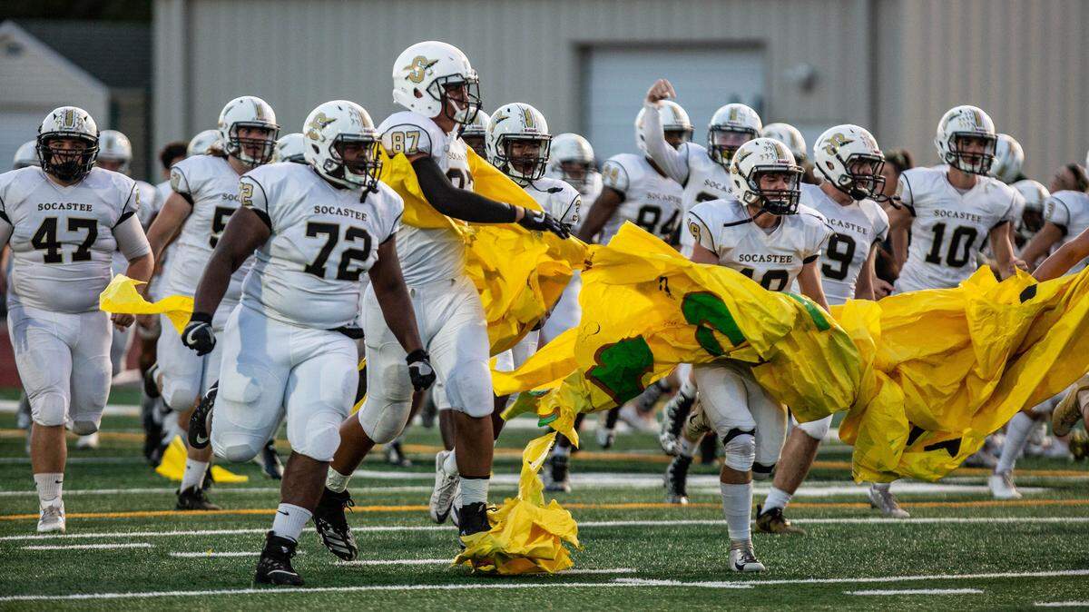 The Socastee Braves run onto the field before their Friday night matchup against the Myrtle Beach Seahawks at Doug Shaw Memorial Stadium Friday night.