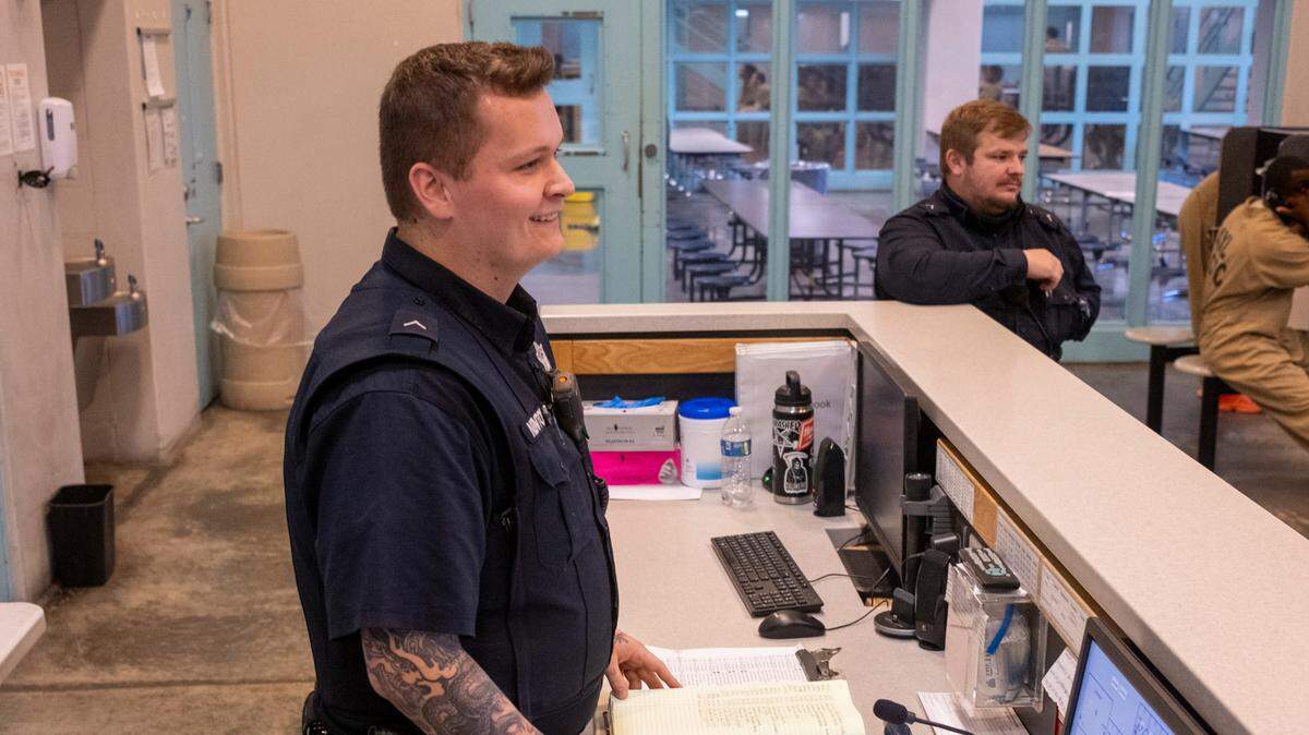 Logan Newton, 20, interacts with inmates at J. Reuben Long Detention Center in Conway, S.C. Newton is one of several correctional officers hired last year after the age requirements were lowered by the state legislature.. Oct. 10, 2023.