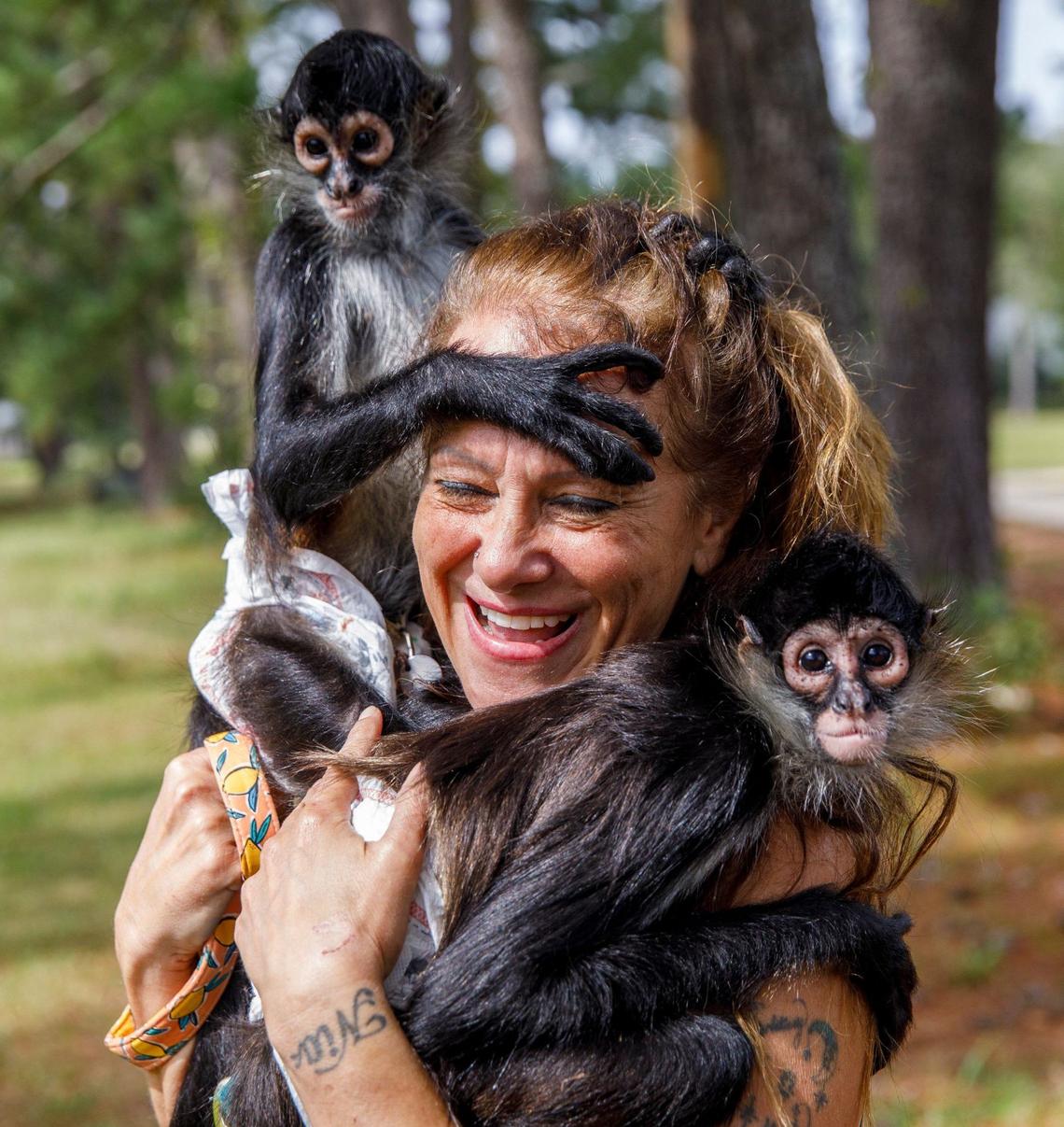 Longs resident Trina Owens with her pet spider monkeys, Charlotte and Pixie.