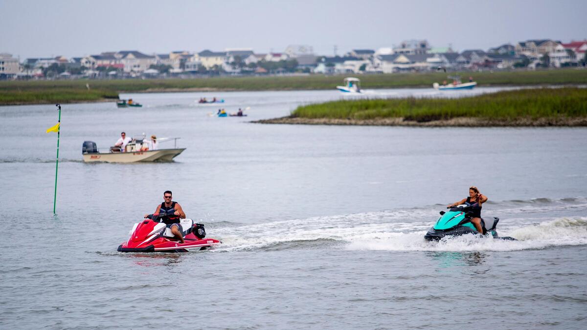 People boat and jet ski along the marsh in Murrells Inlet Sunday afternoon as Memorial Day weekend crowds grow despite the ongoing coronavirus pandemic.