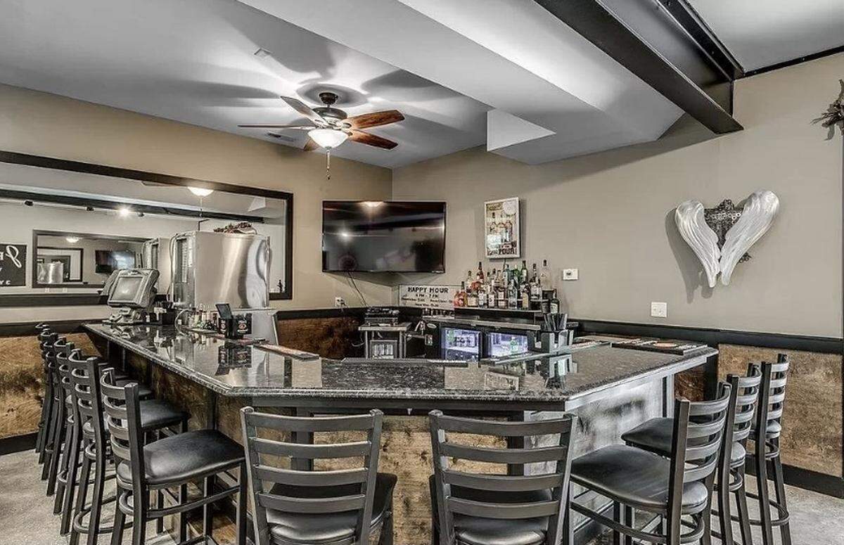 An expensive home is for sale in Pawleys Island, SC. The house is listed on Zillow for $2.9 million. It features a spacious outdoor area with a pool and cabana.
