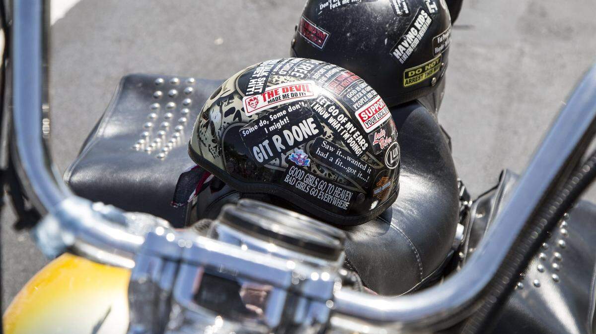 Helmets with stickers rests on the seat of a Harley Davidson motorcycle at the Spring Rally. File photo.