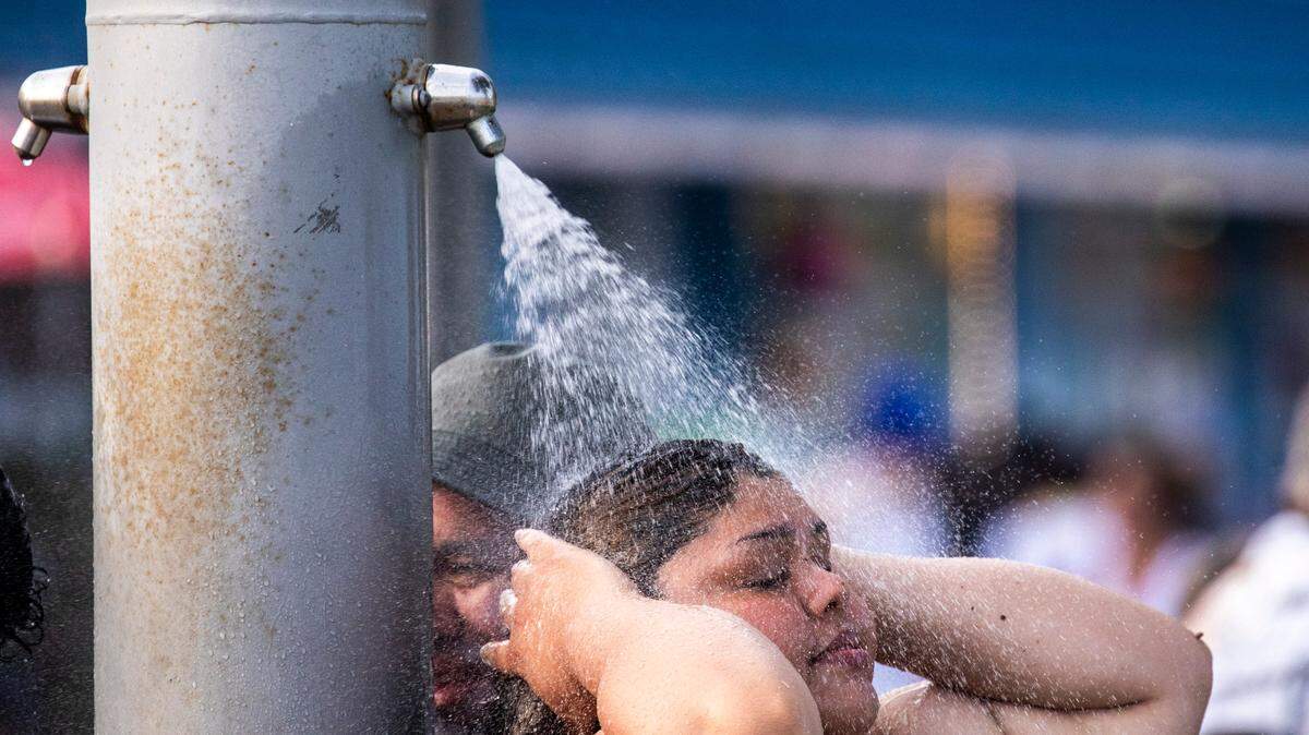Lines formed on the Myrtle Beach boardwalk to wash the sand and salt off at public showers following a day on the beach. Despite a heatwave, crowds arrive in Myrtle Beach for the July 4th weekend on Saturday. Tourists packed beaches, cruised the boulevard and enjoyed fireworks at the Myrtle Beach Pelicans baseball game. July 1, 2023.