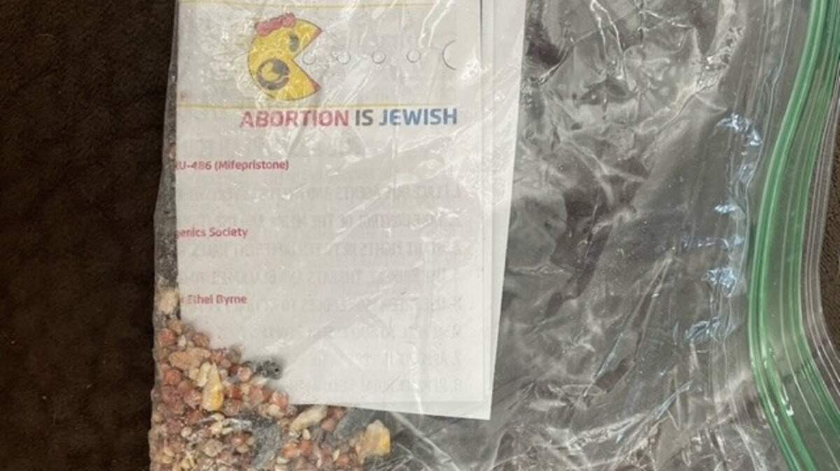 Janet Elkins received a plastic baggie filled with hate message flyers on her lawn Wednesday. She is among several people in The Farm at Timberlake community off Highway 707 that received the baggies on their lawns.