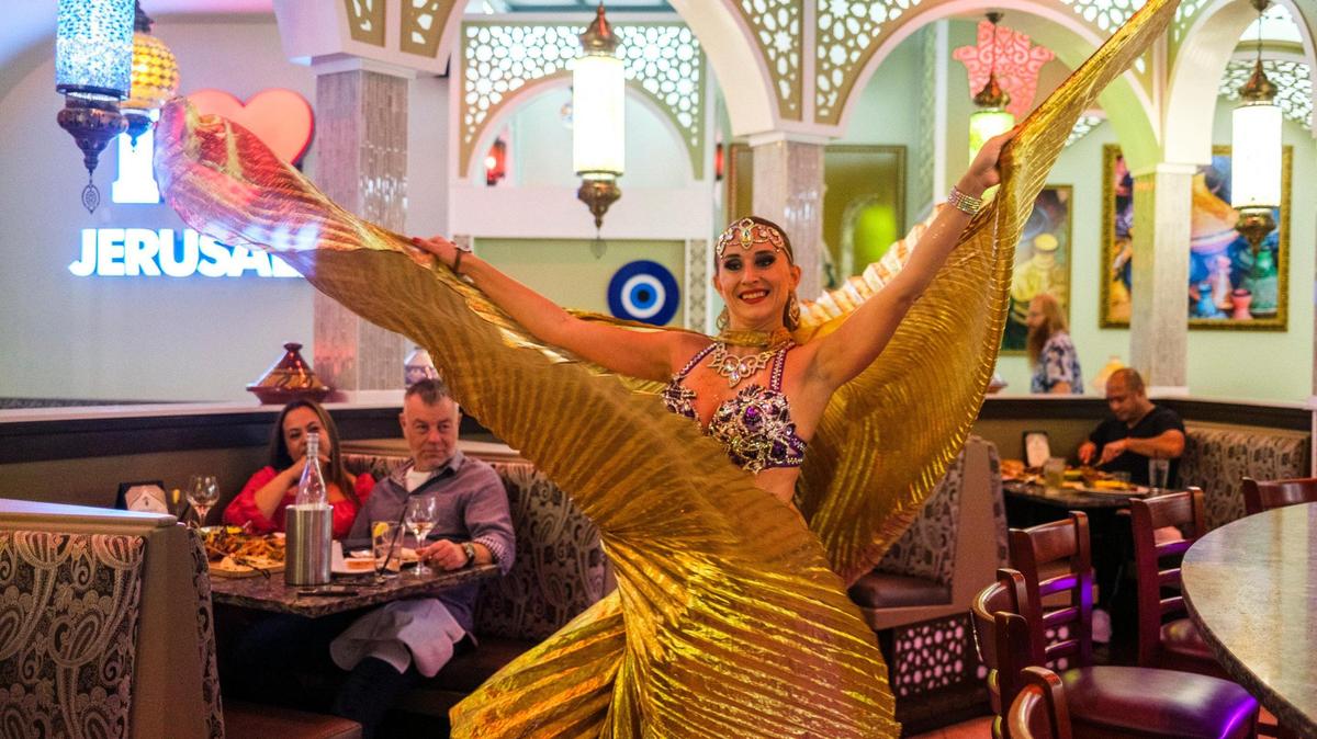 Julia Crystal of Camila Dance Show performs a belly dancing and light show at the Jerusalem Mediterranean Restaurant in Myrtle Beach, S.C. Jan. 3, 2024.