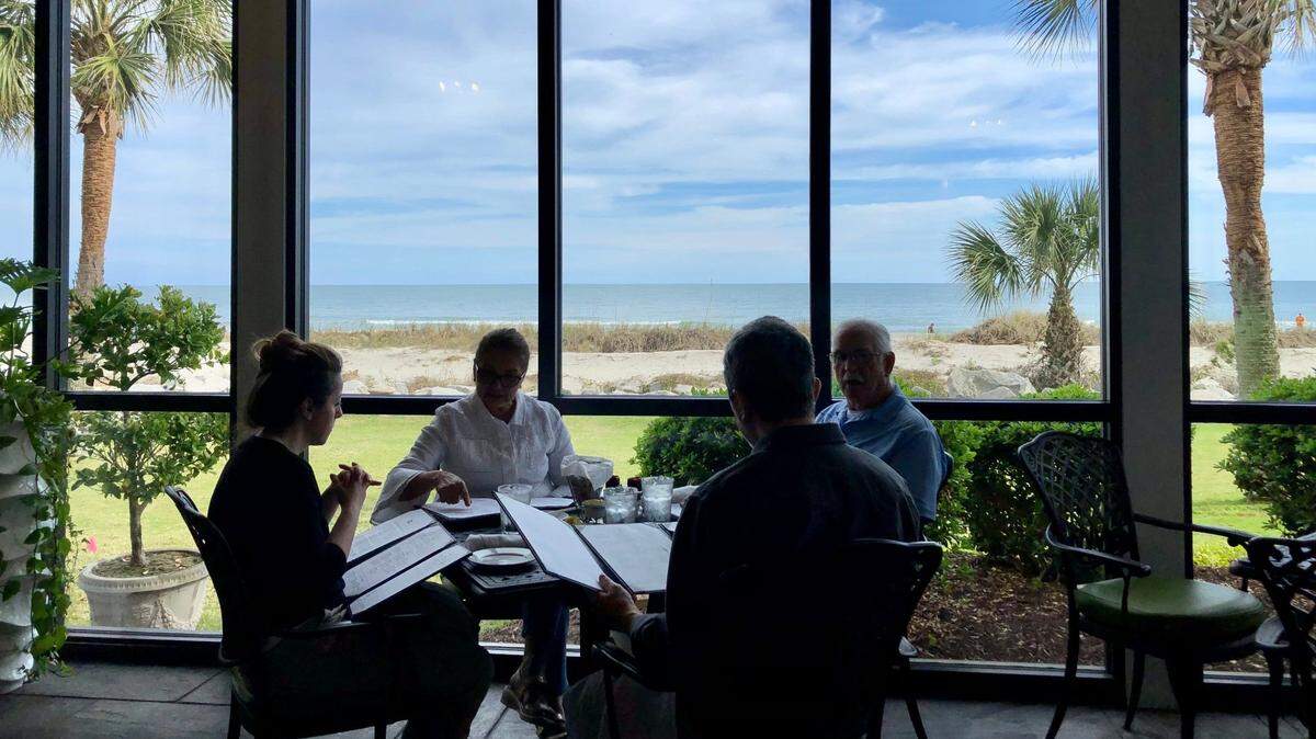 Diners enjoy a sunny coastal afternoon at Sea Captain's House. March 6, 2023.