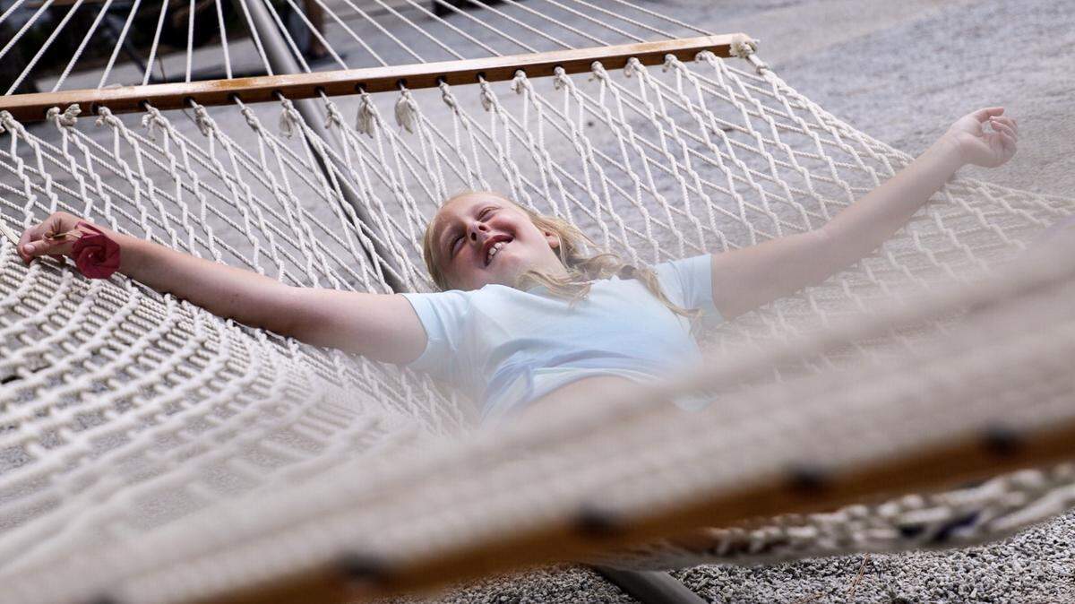 Abigail Guyton of Greenville, SC swings in a hammock outside of the Pawley’s Island Hammock Shops on Thursday.
