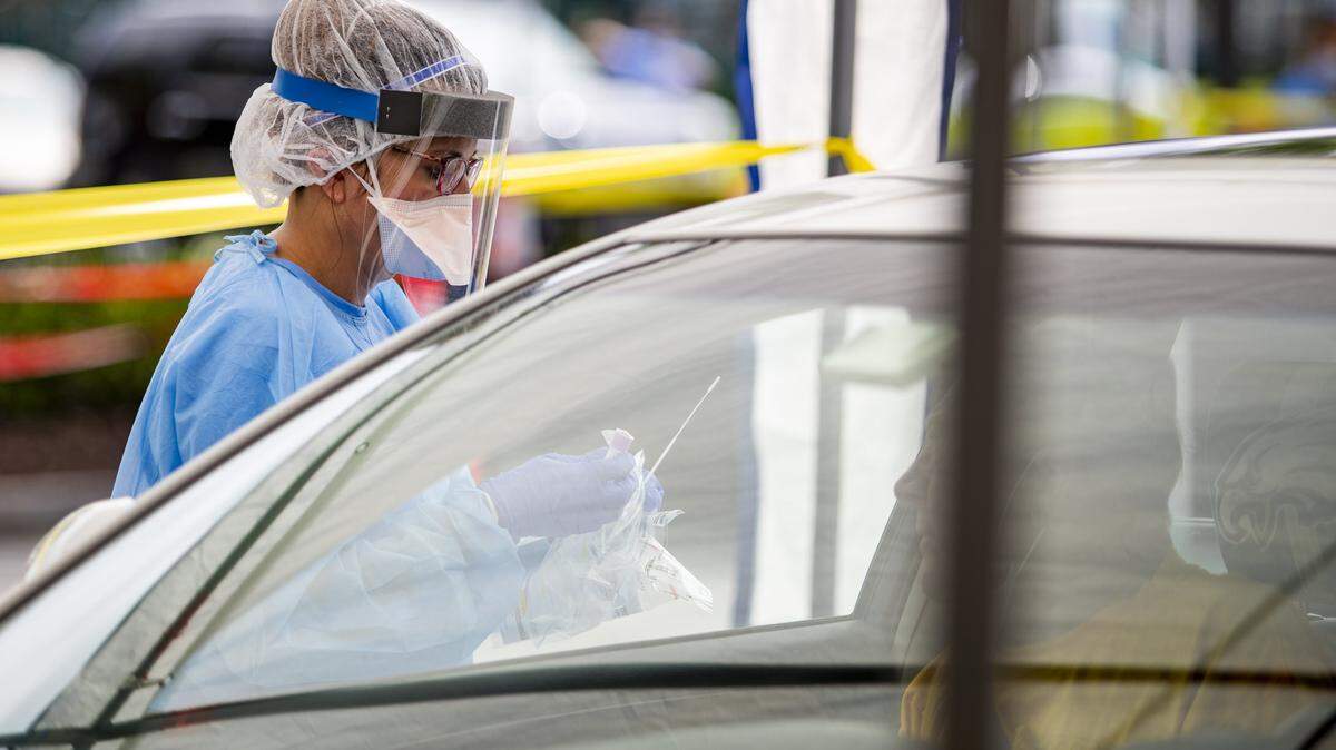 Mary Keller, R.N., prepares to conduct a COVID-19 test Saturday morning as Tidelands Health and DHEC partnered to host a drive-thru COVID-19 testing facility at Pelicans Stadium in Myrtle Beach. Hundreds lined up for the first day of the clinic.