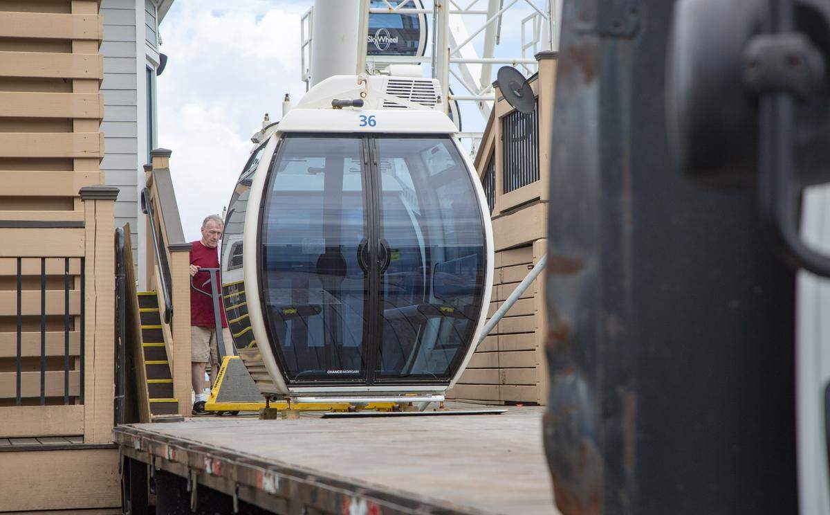 Crews work to load gondolas on to a truck in 2018 at the Myrtle Beach SkyWheel in preparation for the arrival of Hurricane Florence.
