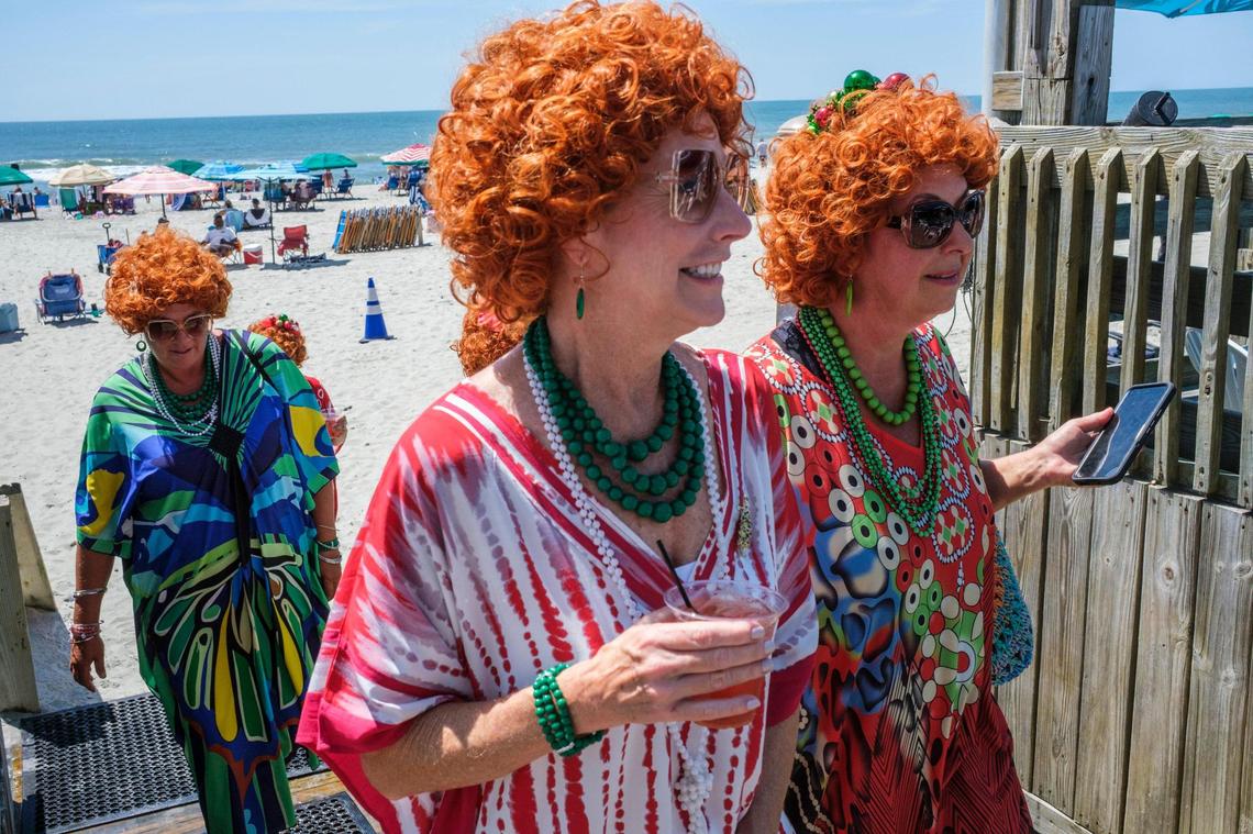 The Grand Strand Chapter of the International Order of Mrs. Ropers, a club where participants dress as Helen Roper from the late 1970s to 1980s TV series “Three’s Company,” went on a pub crawl with Tito’s Trolley Company in Myrtle Beach on Saturday. The group visited several area bars taking pictures and joking with other patrons. July 18, 2025.