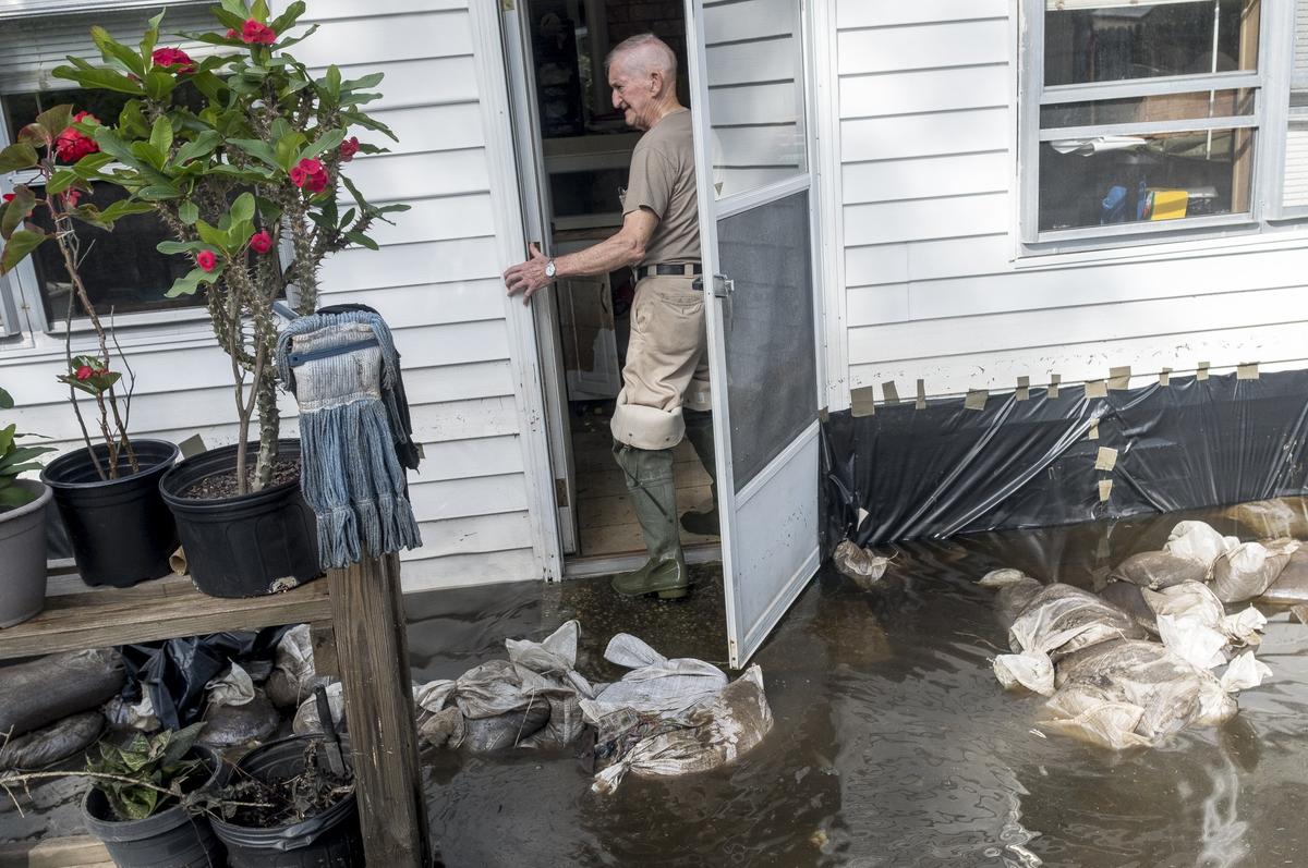 Martin Quandt (77) looks over his flooded home in the Rosewood community where water crossed his sandbag barriers and overtook his home. While much of the Rosewood community in Socastee in still under water from Hurricane Florence’s flooding, a few residents were able to return to assess the damage and begin cleaning on Tuesday. October 2, 2018.
