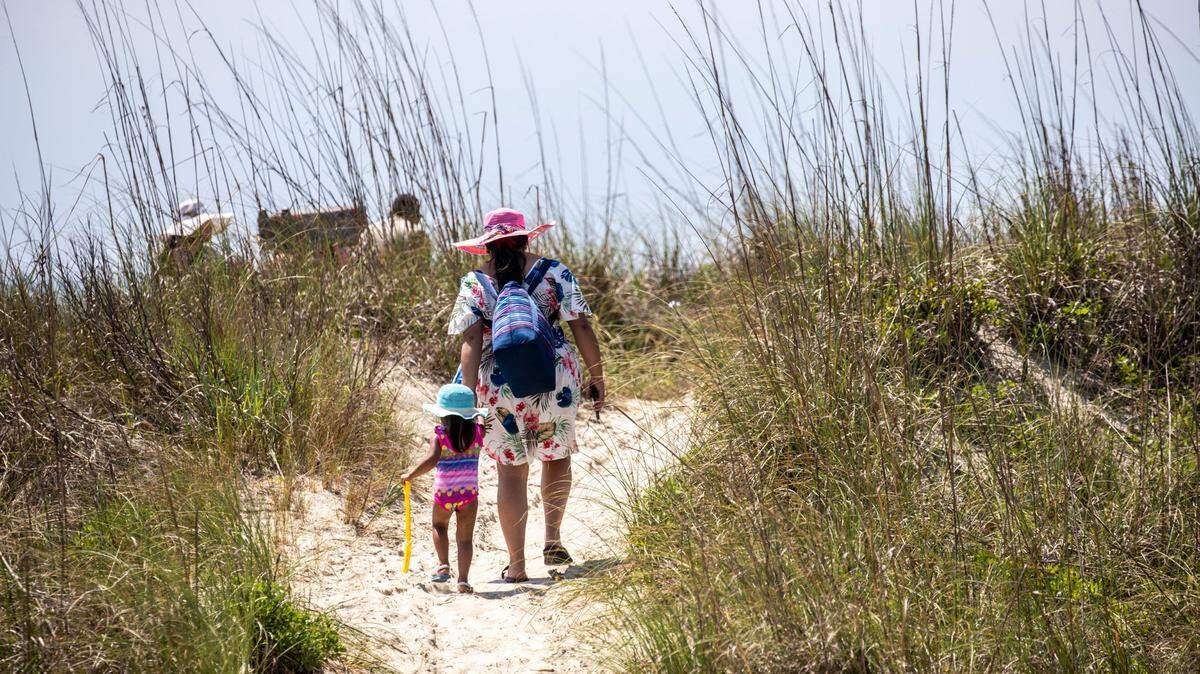A family makes their way across the dunes to Atlantic Beach. June 13, 2022.