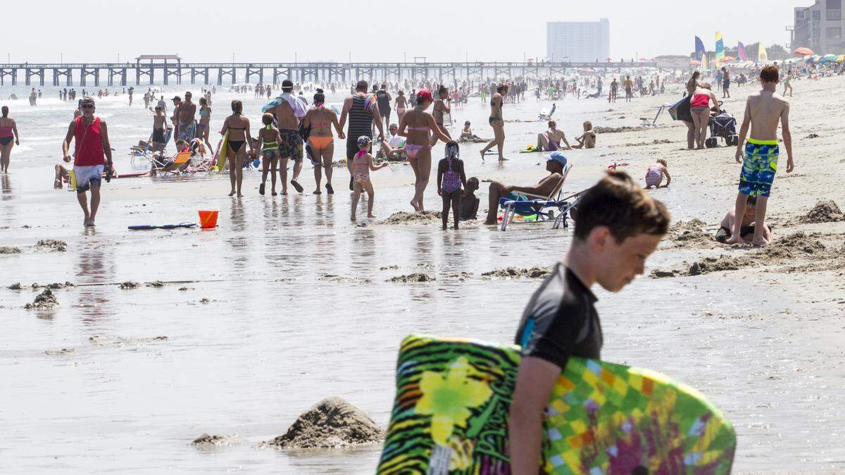 Sunbathers fill the beach near 24th Avenue South on Thursday, July 21 2016.