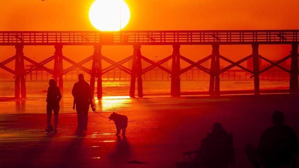 Beachgoers enjoy a November sunset in the Cherry Grove section of North Myrtle Beach on Friday, Nov. 18, 2016.