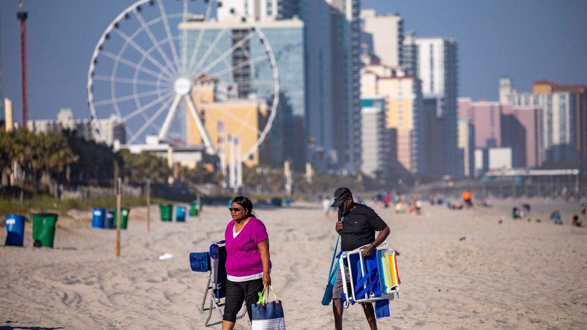 Visitors to Myrtle Beach pack up after a day on the beach on Friday. Grand strand residents and visitors head for the beach on the first sunny weekend of Spring. March 24, 2023.