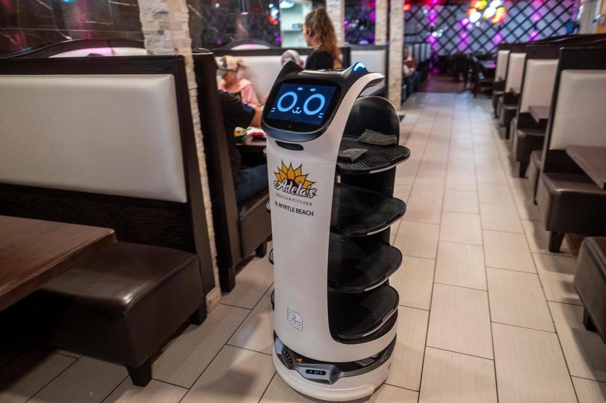 Robotic waiters carry food to tables at Adela’s Mexican Kitchen, in North Myrtle Beach, S.C. Jan. 25, 2024.
